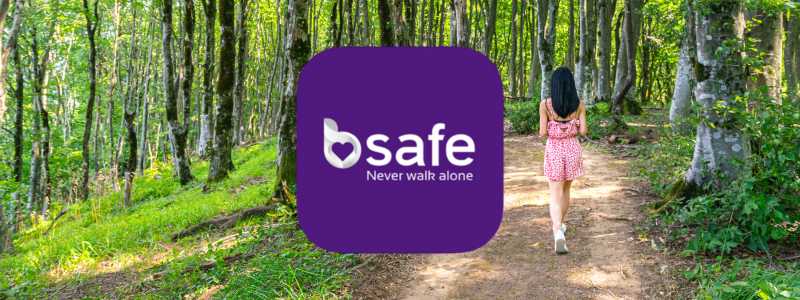 bSafe logo layered over an image of a dusk-lit trail through the woods, evoking discreet personal safety in motion.