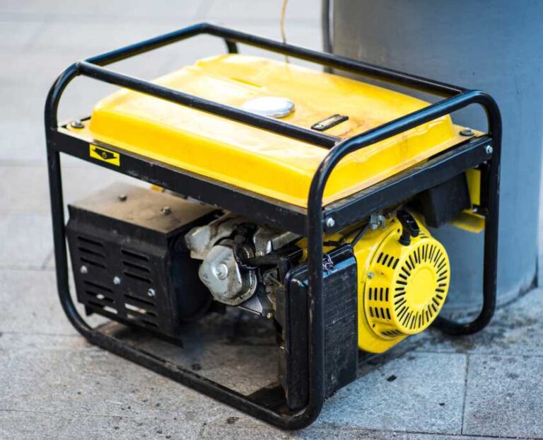 Fuel-powered generator placed outdoors on a concrete surface, illustrating a traditional backup power option for emergencies.