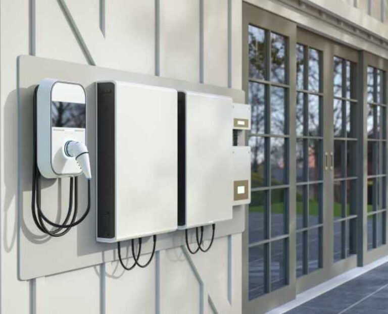 Home battery system mounted on exterior wall, part of a residential backup power setup for emergencies as example of stored electricity.